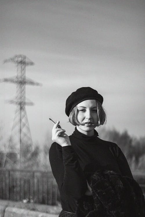  Grayscale Photo of a Woman Holding a Cigar 