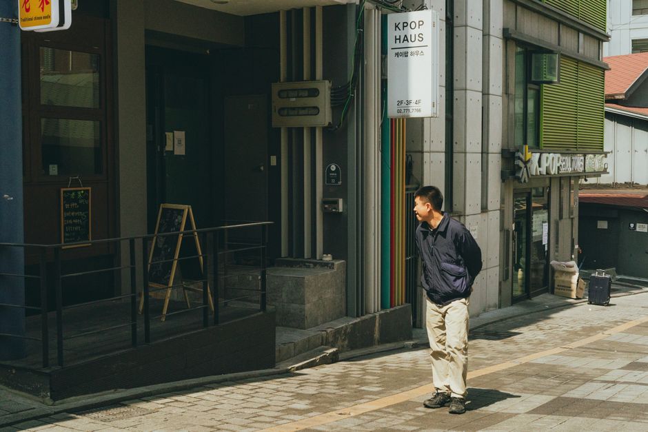 A man walks in front of a K-pop themed building in downtown Seoul, South Korea.