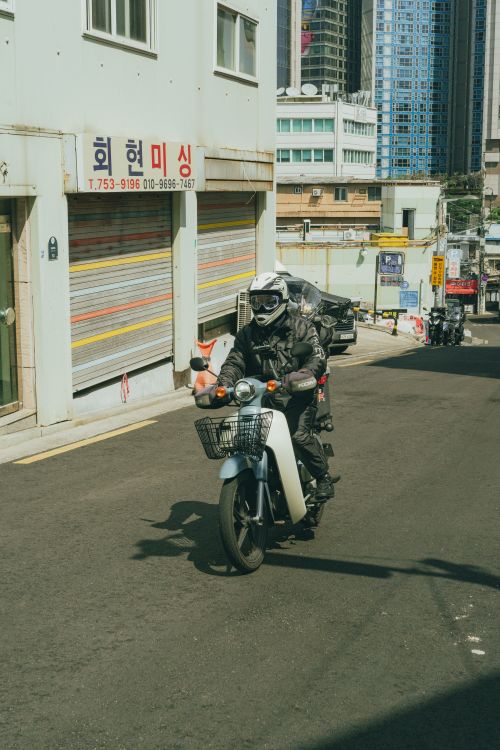 Free A motorcyclist rides through the vibrant streets of Seoul, South Korea during spring. Stock Photo
