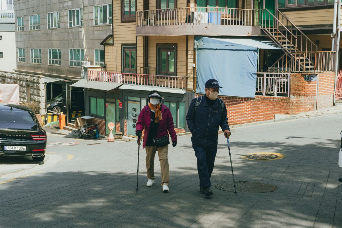 Elderly couple walking on a hilly street in Seoul, South Korea