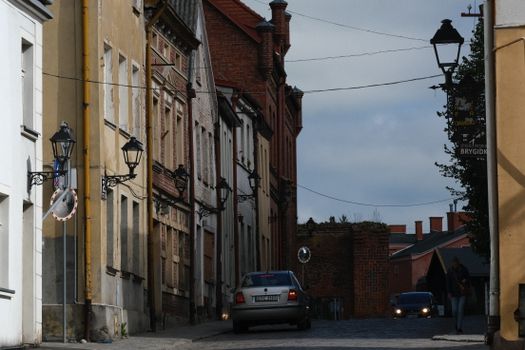 Quaint European street view featuring historical architecture and vintage lampposts.