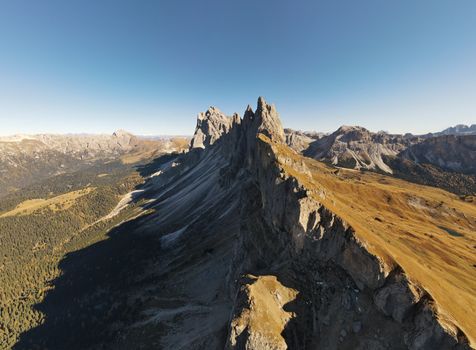 Aerial view of the rugged Seceda mountain peaks in Trentino-Alto Adige, Italy during fall.