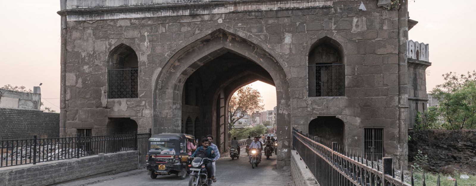 Traffic passing through a historic gate in Aurangabad, Maharashtra during daytime.