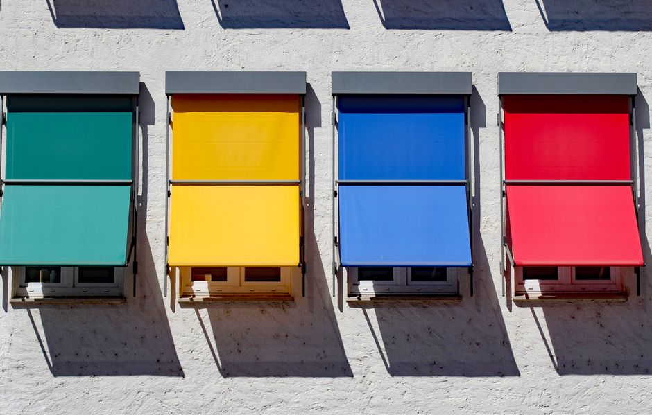 Vibrant awnings in primary colors on a building facade, Donauwörth, Germany.