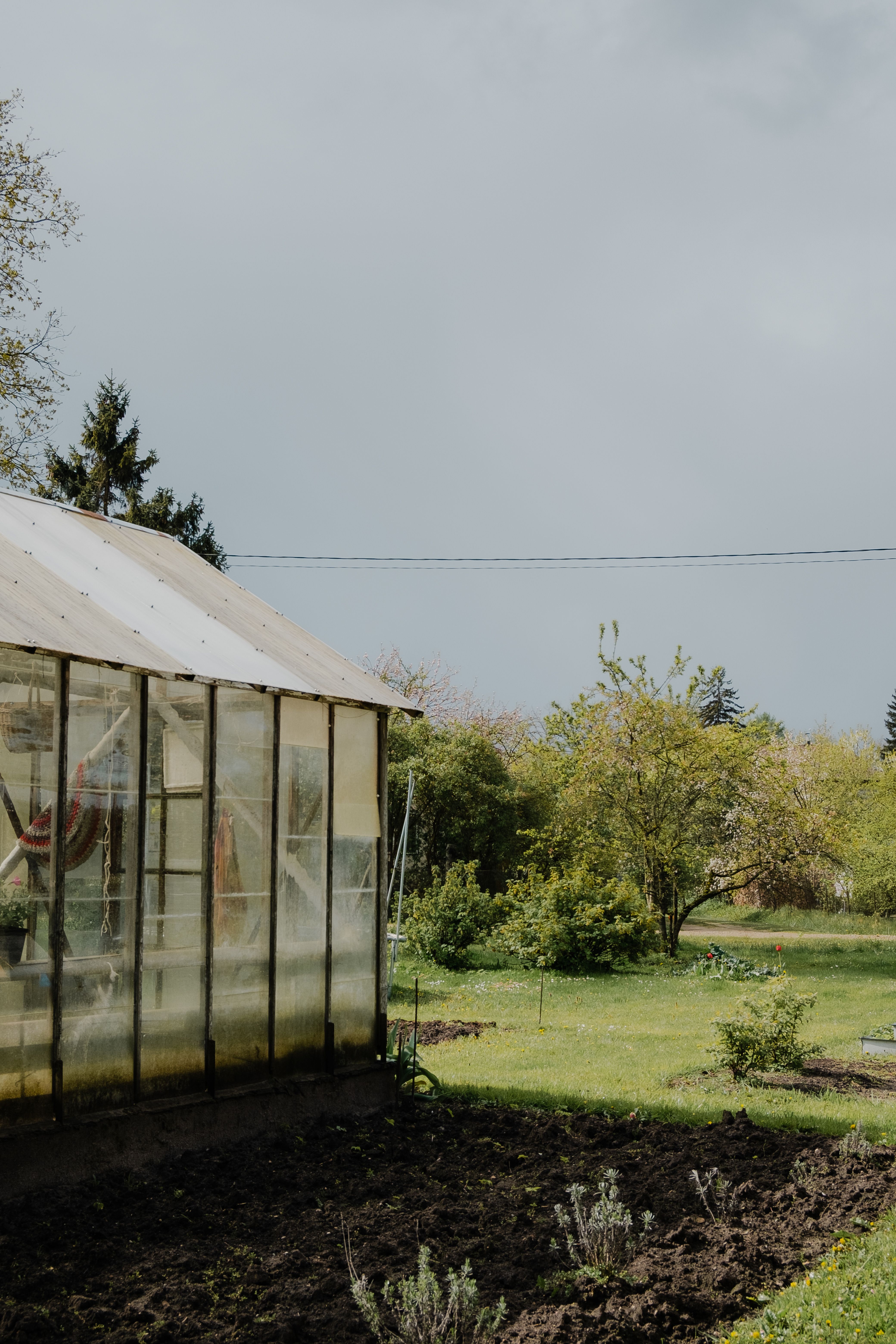 Greenhouse in a Serene Spring Garden · Free Stock Photo