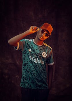 Portrait of a young man in sunglasses and cap, exuding urban style.