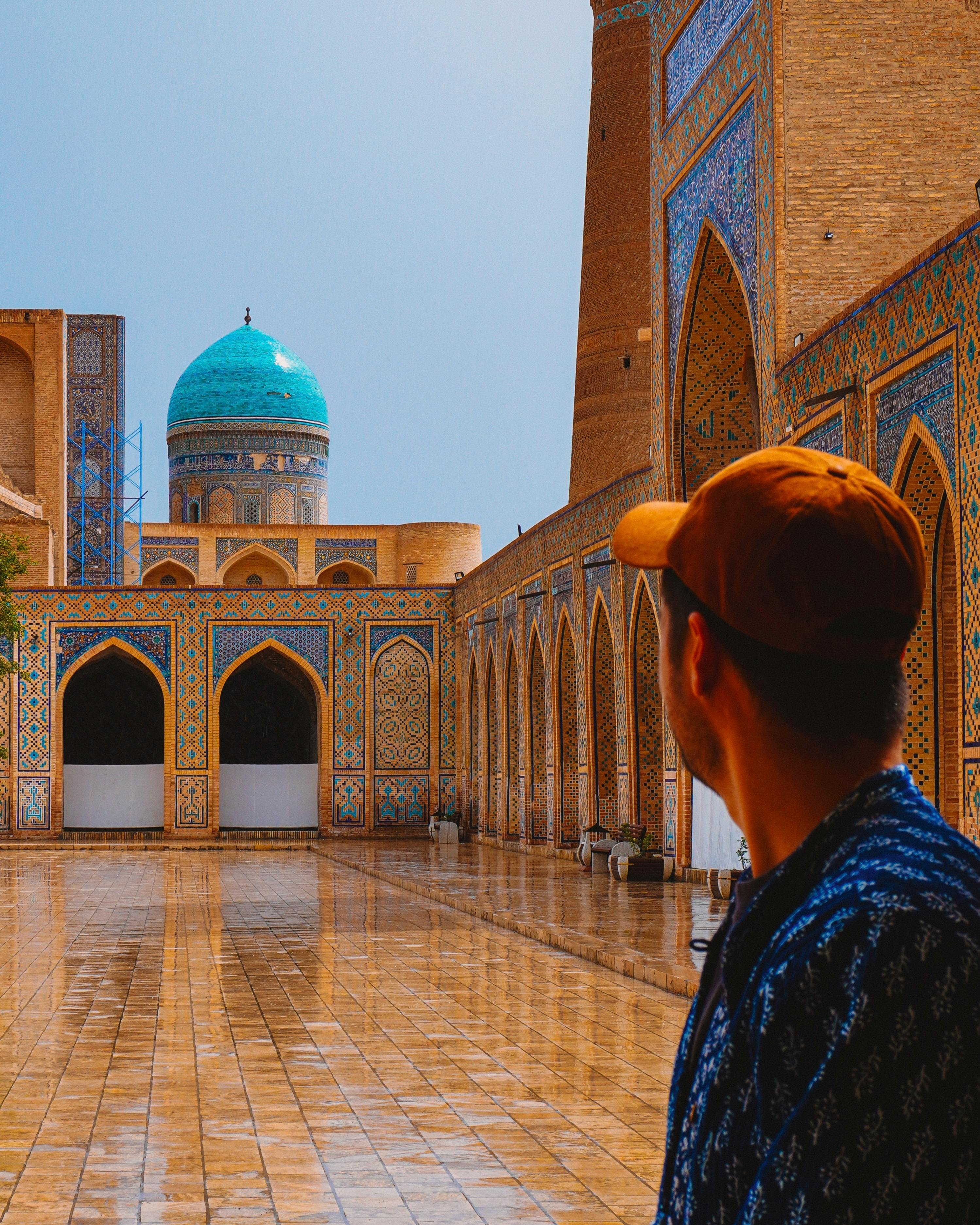 Explore the historic madrasa courtyard in Bukhara with stunning Islamic architecture.
