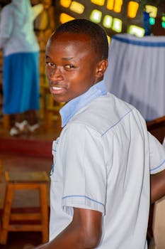 Portrait of a smiling teenager in a school setting with colorful background.