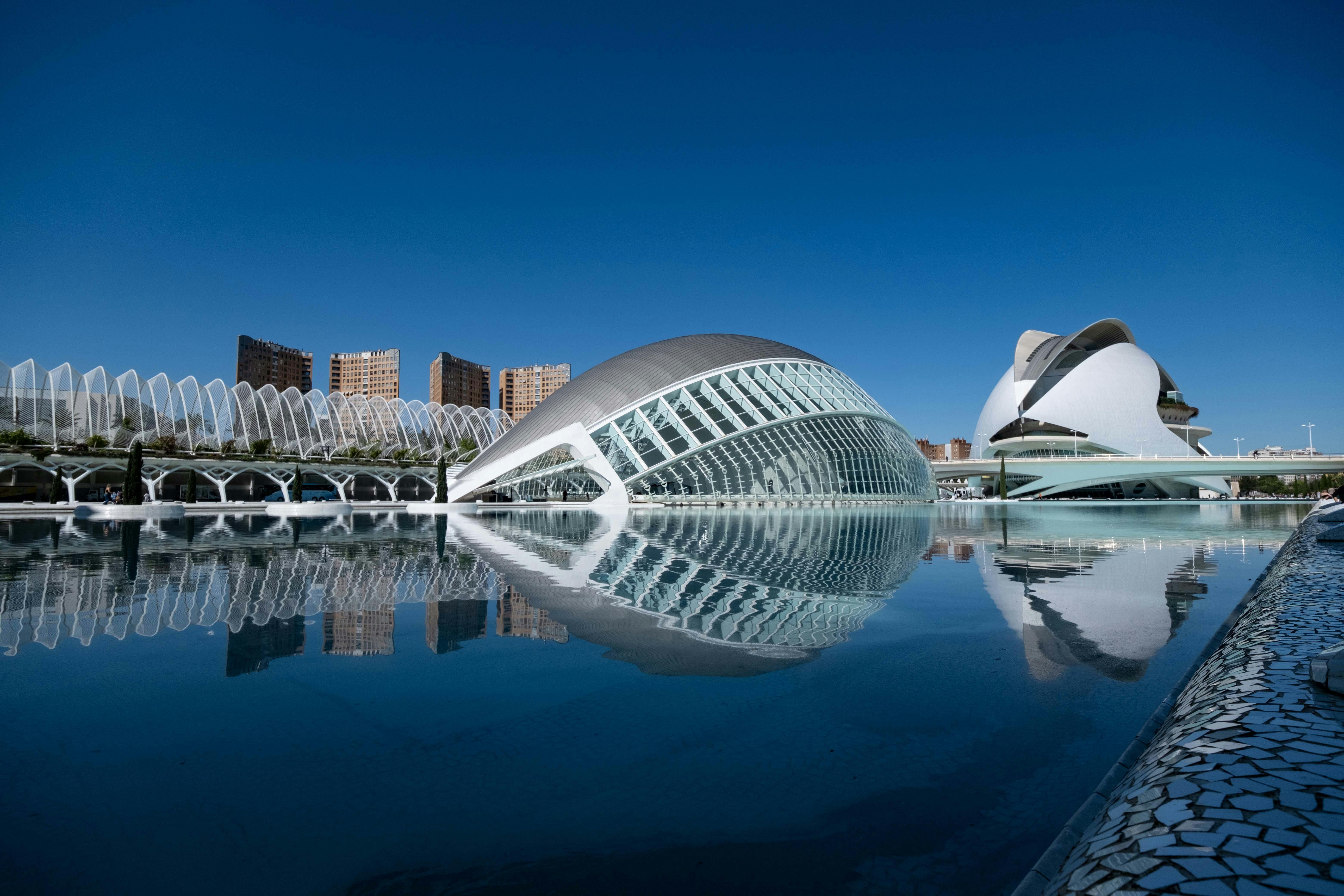 Modern architecture reflected in water at the City of Arts and Sciences in Valencia.