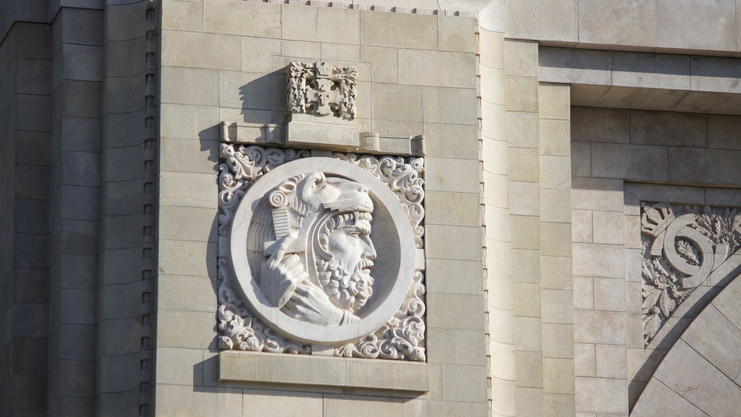 Close-up of a detailed stone relief on an ancient architectural monument.
