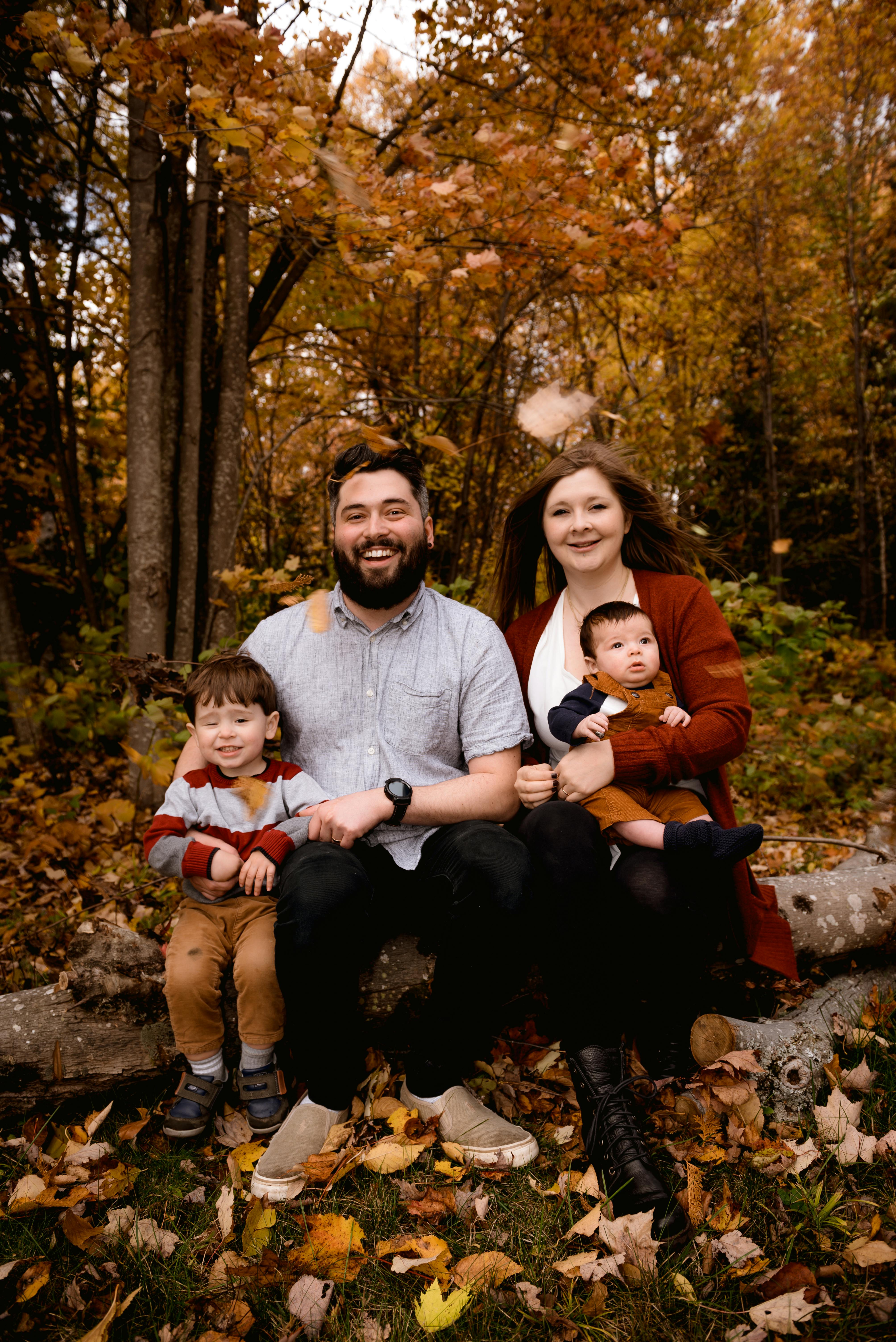 Photo of Family Sitting on Tree Log