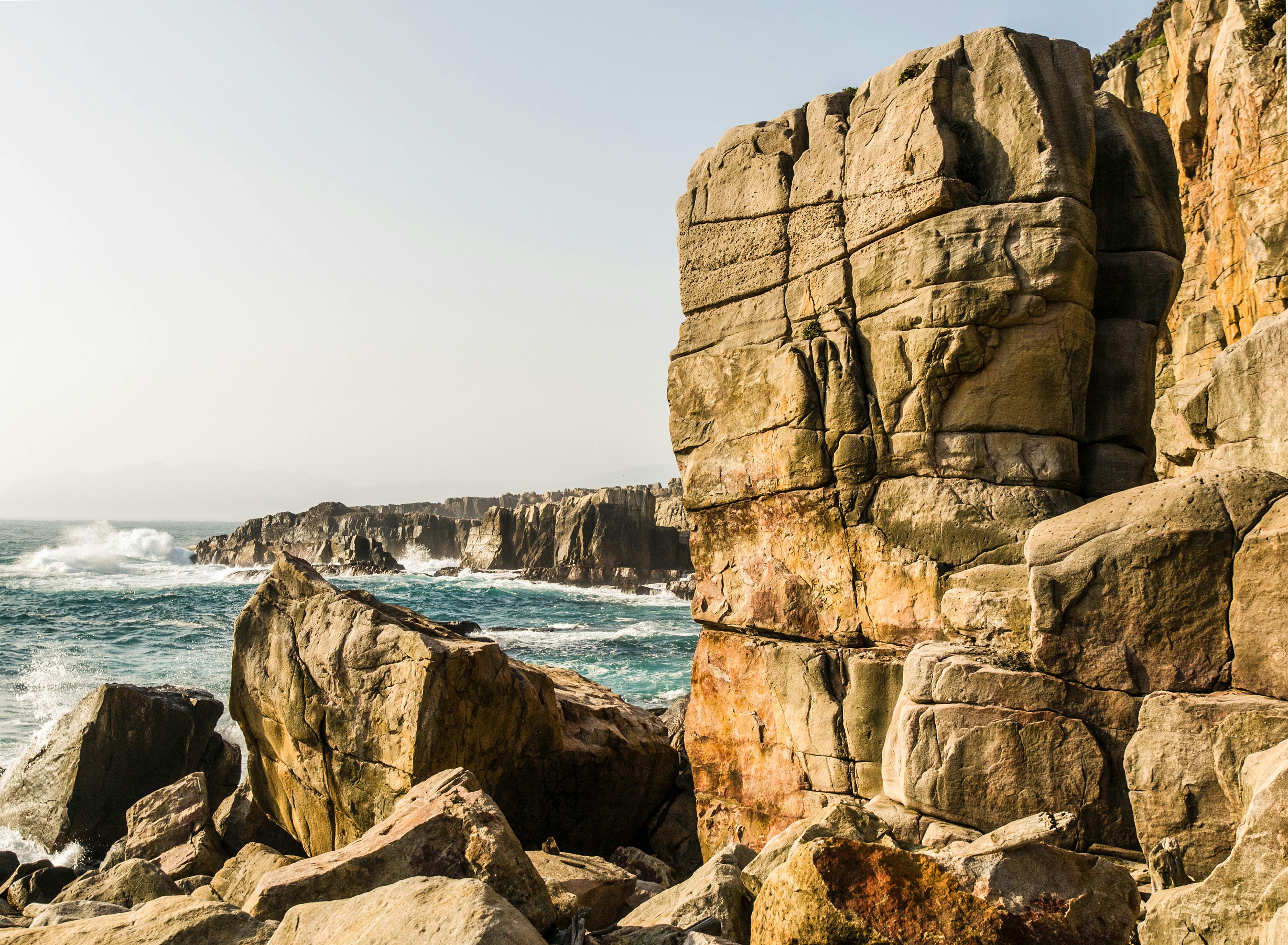Dramatic coastal rock formations rising from the sea — similar to Gotland's raukar