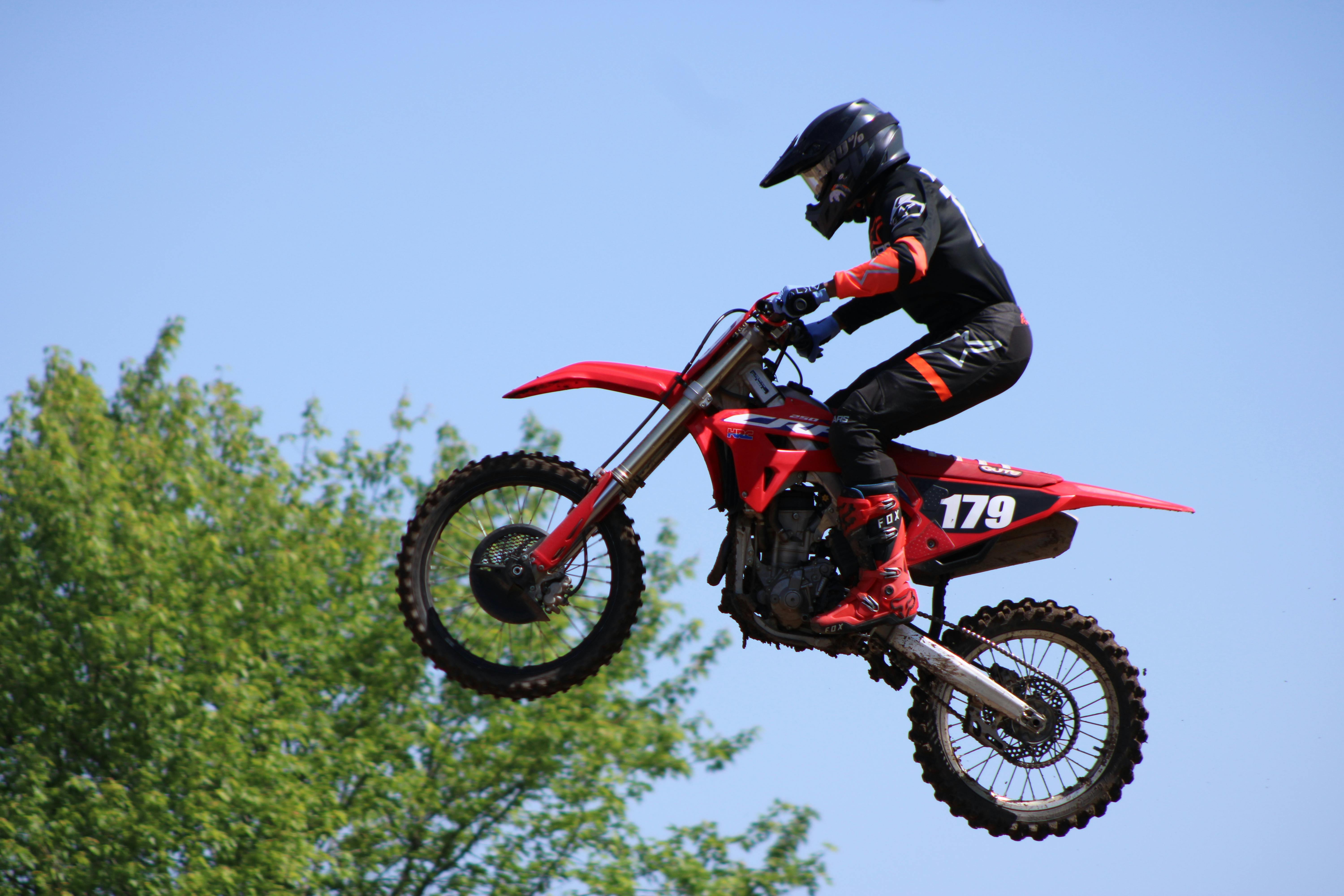 Exciting motocross jump by dirt bike rider in Carroll, Ohio under clear skies.