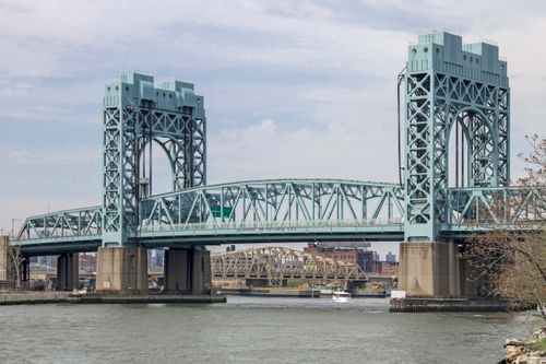 Free View of the historic steel bridge in New York City, spanning the Harlem River on a clear day. Stock Photo