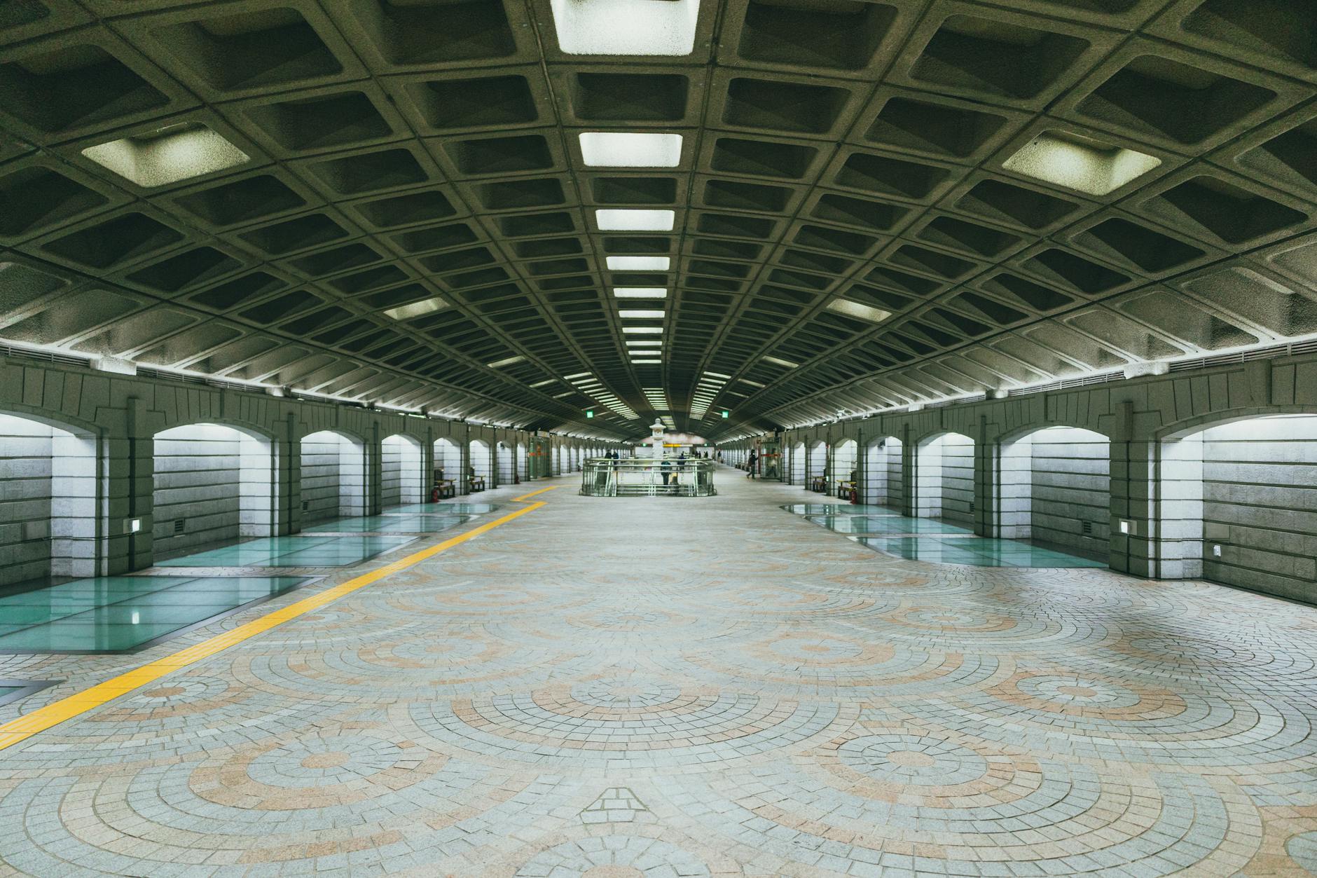Wide view of a modern and symmetrical subway station in Seoul, South Korea.