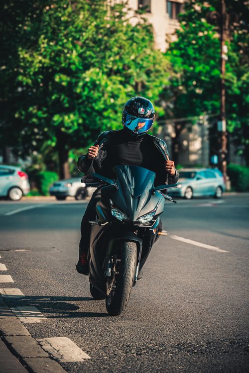 Free Man riding a sportbike on a city street in daylight. Stock Photo