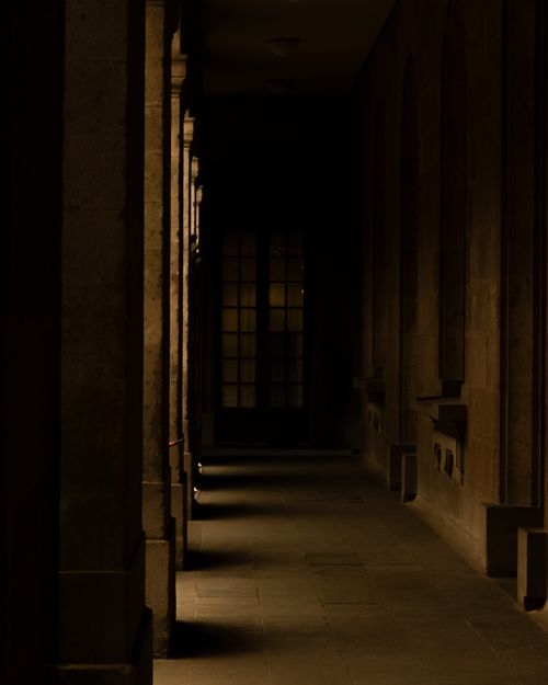 Free A moody corridor with striking light and shadow contrast, located in a historic building in Ciudad de México. Stock Photo