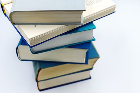 Stack of blue hardcover books on white