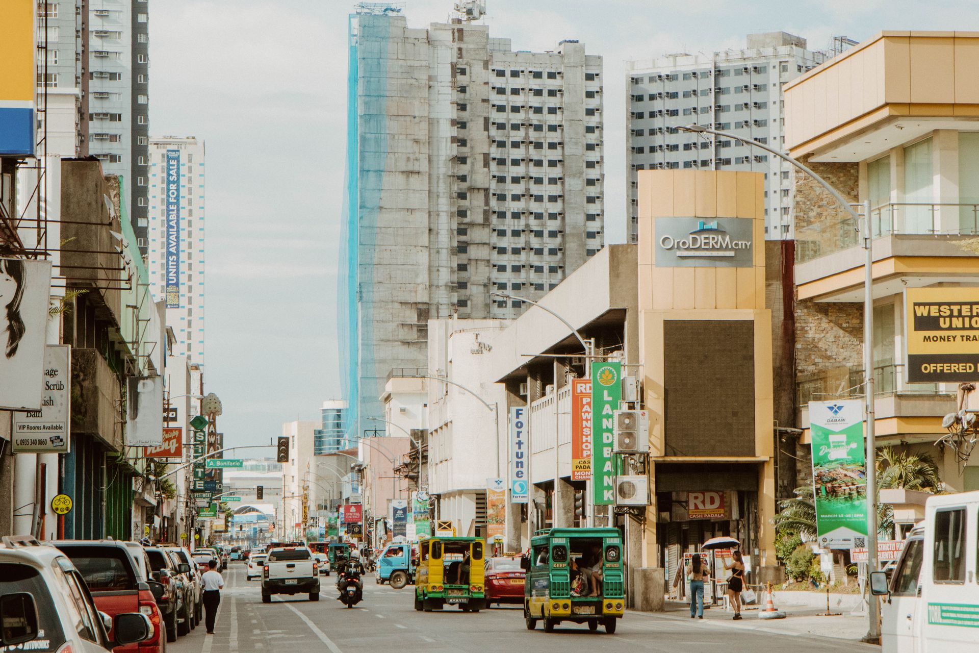 Dynamic urban landscape of Davao City featuring busy streets and towering buildings.
