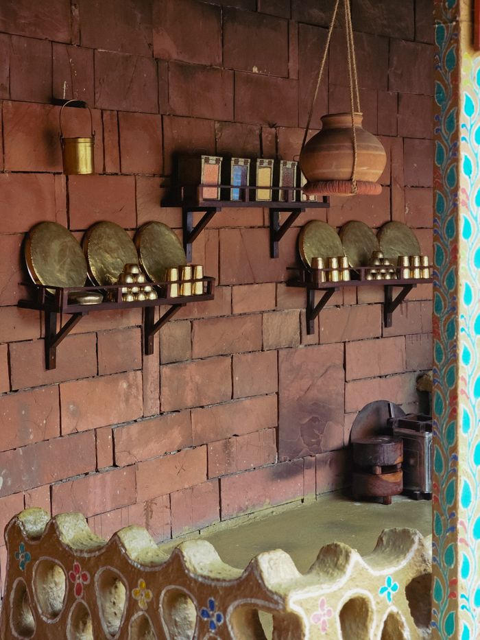 Real photo of a traditional Indian kitchen with brass utensils