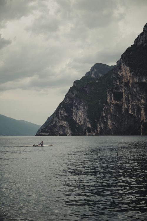 Dramatic Rowing Tranquil Rowing Scene by Majestic Cliffs · Free Stock Photo