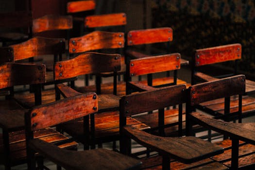 A collection of vintage wooden classroom chairs in Batangas, creating a nostalgic and warm atmosphere.