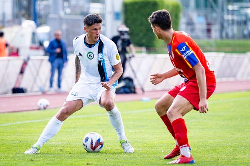 Free Dynamic moment of two players competing intensely during a soccer match on a sunny day. Stock Photo