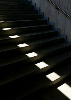 Dramatic interplay of light and shadow on steps creates an abstract effect.