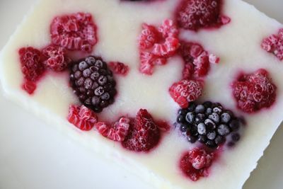 Close-up of frozen berries on a creamy yogurt bar