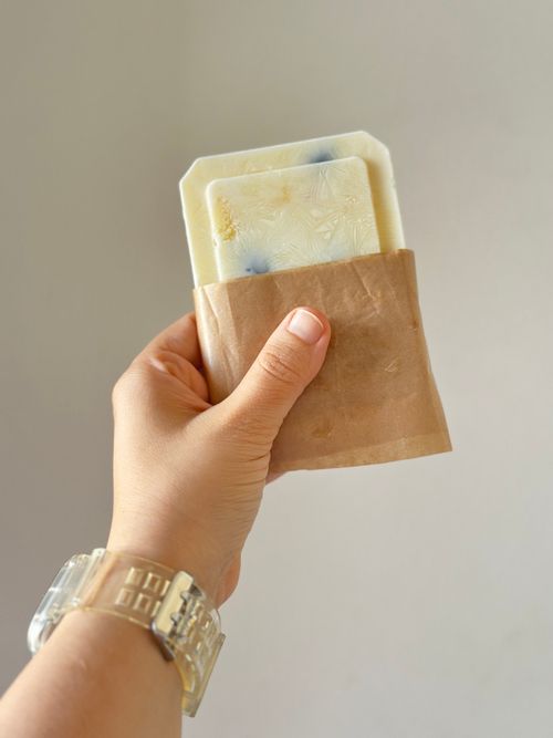 Free Close-up of a hand holding eco-friendly handmade soap with a natural paper cover. Stock Photo
