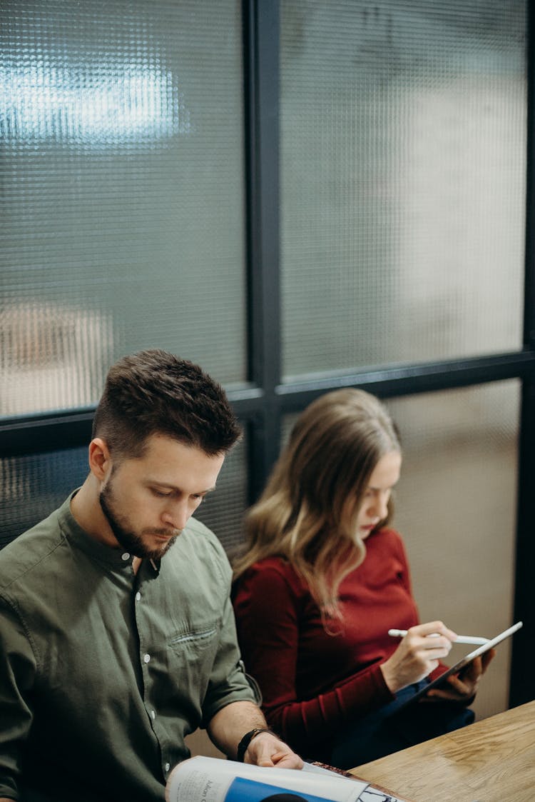 Man And Woman Sitting Near The Table