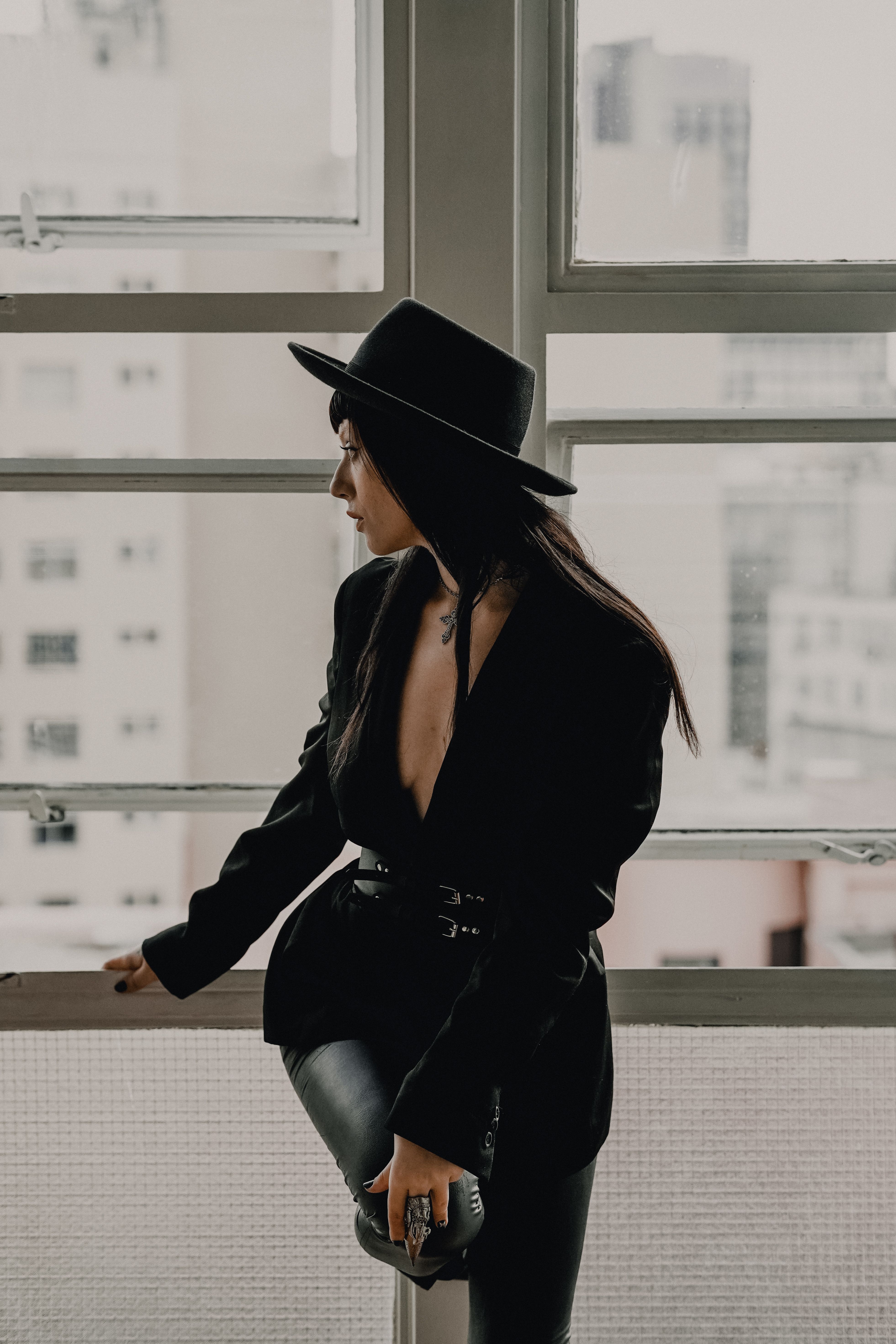 Stylish Woman in Black Hat Looking Out Window · Free Stock Photo
