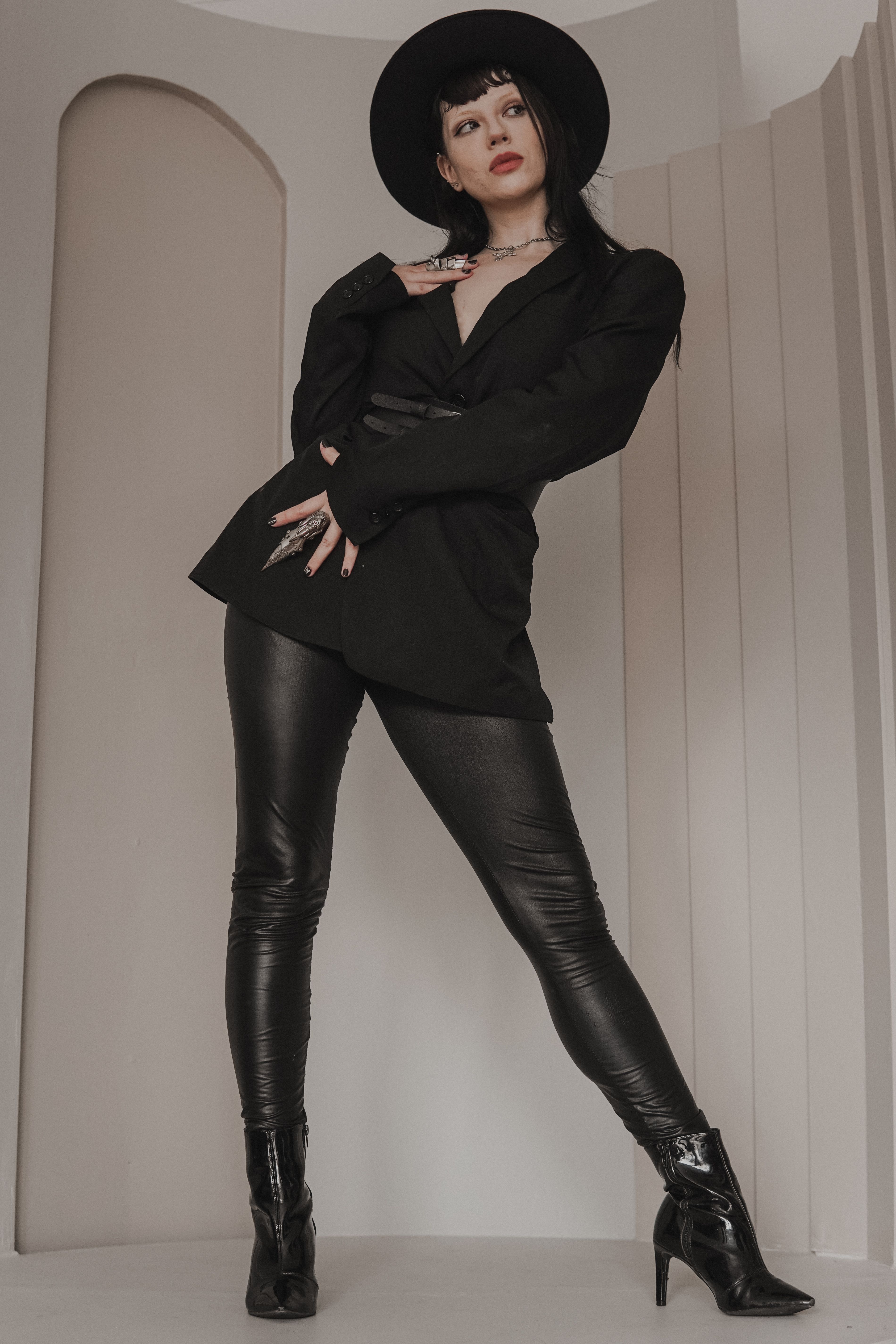 Woman in Black Leather Jacket and Black Pants Sitting on Brown Wooden ...