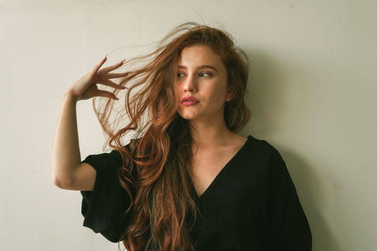 Editorial portrait of a woman with long flowing hair