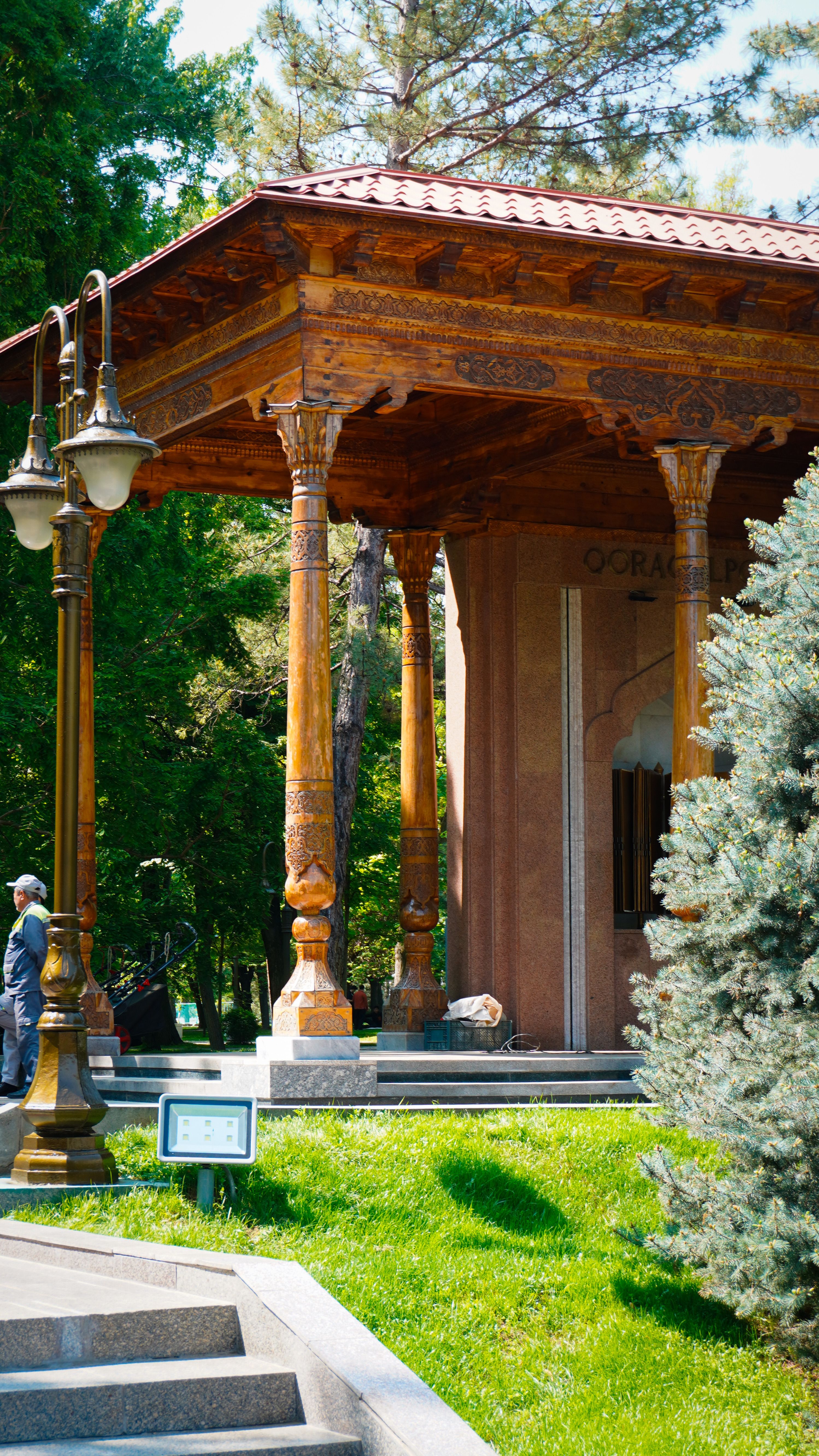 Charming pavilion with intricate woodwork in a Tashkent park, capturing serene outdoor ambiance.