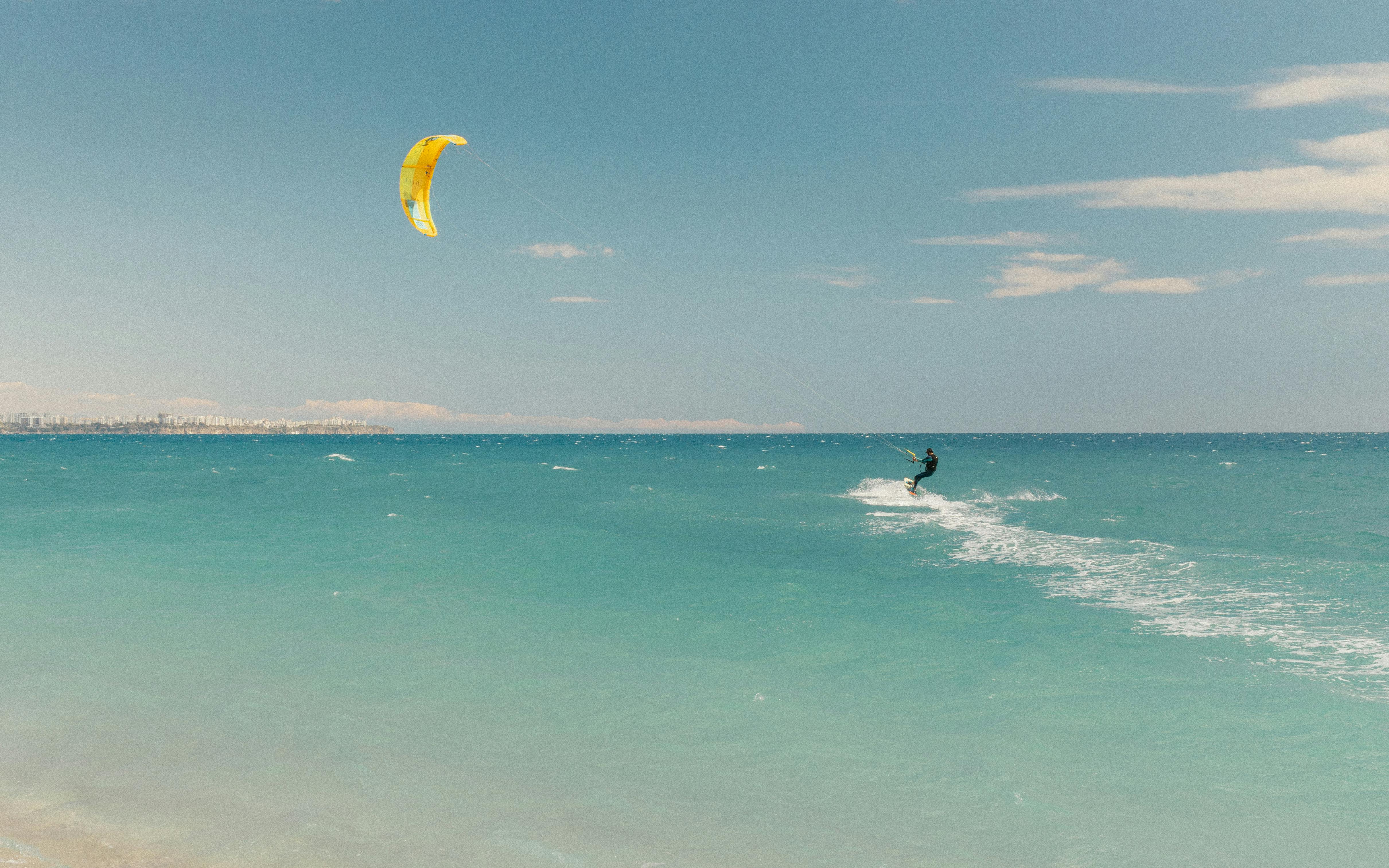 Experience the thrill of kitesurfing on the turquoise waters off Antalya, Türkiye.