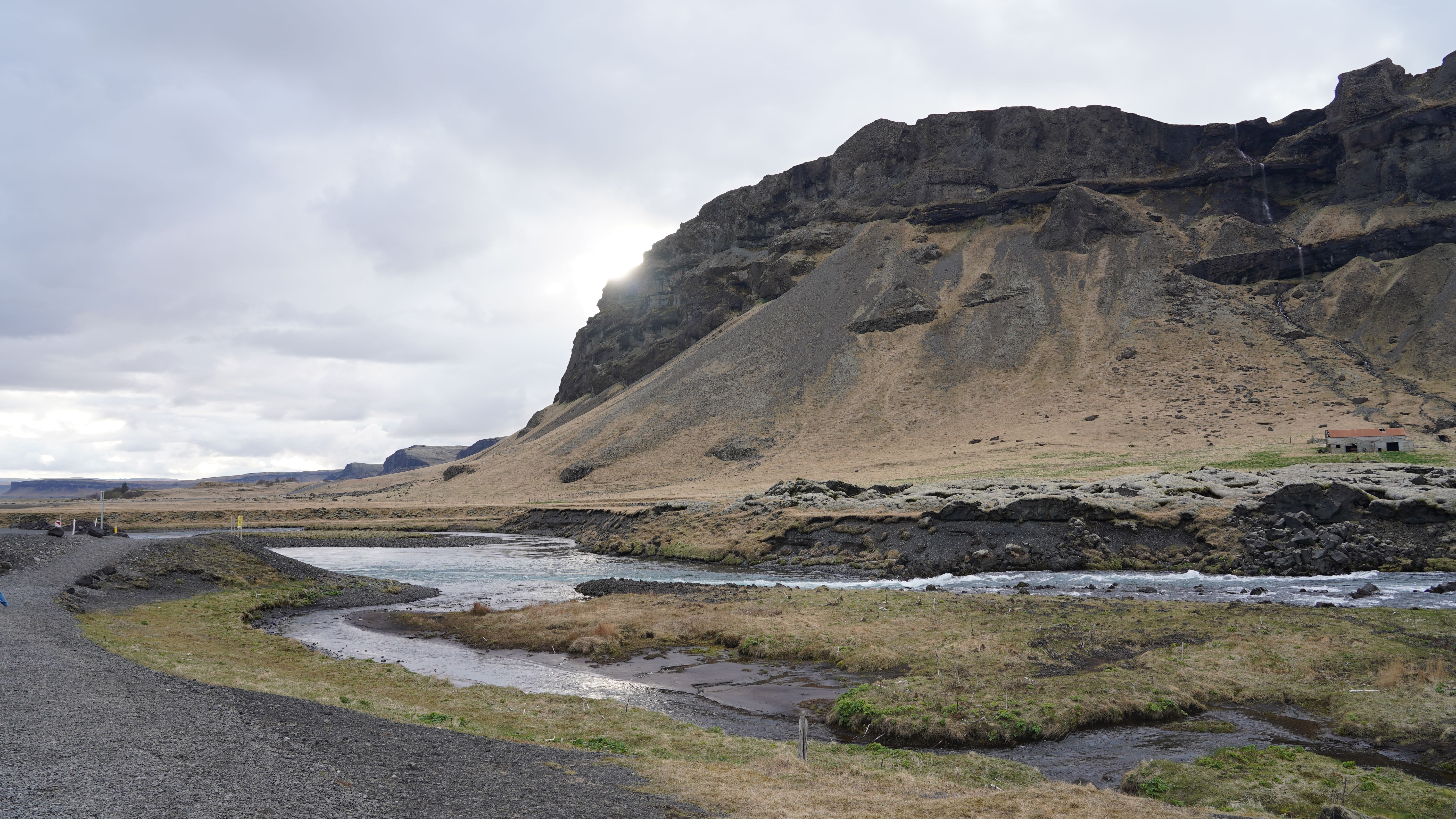 Breathtaking view of the rugged terrain and flowing river in Egilsstaðir, Iceland.