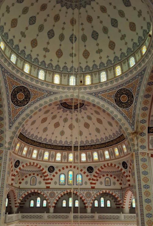 Free Beautiful interior of a mosque featuring intricate dome architecture and Islamic art. Stock Photo
