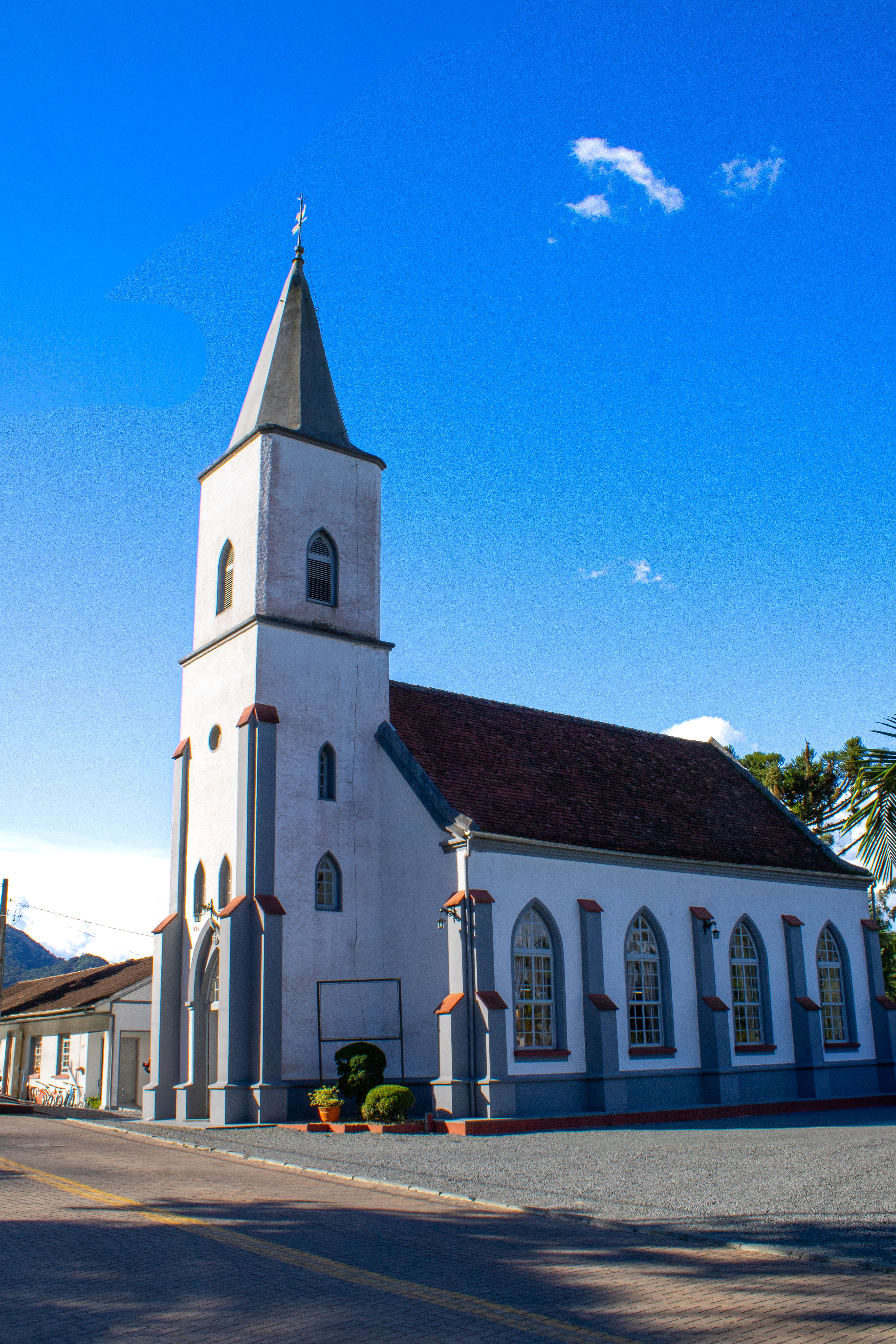 Charming White Church with Blue Sky Background · Free Stock Photo
