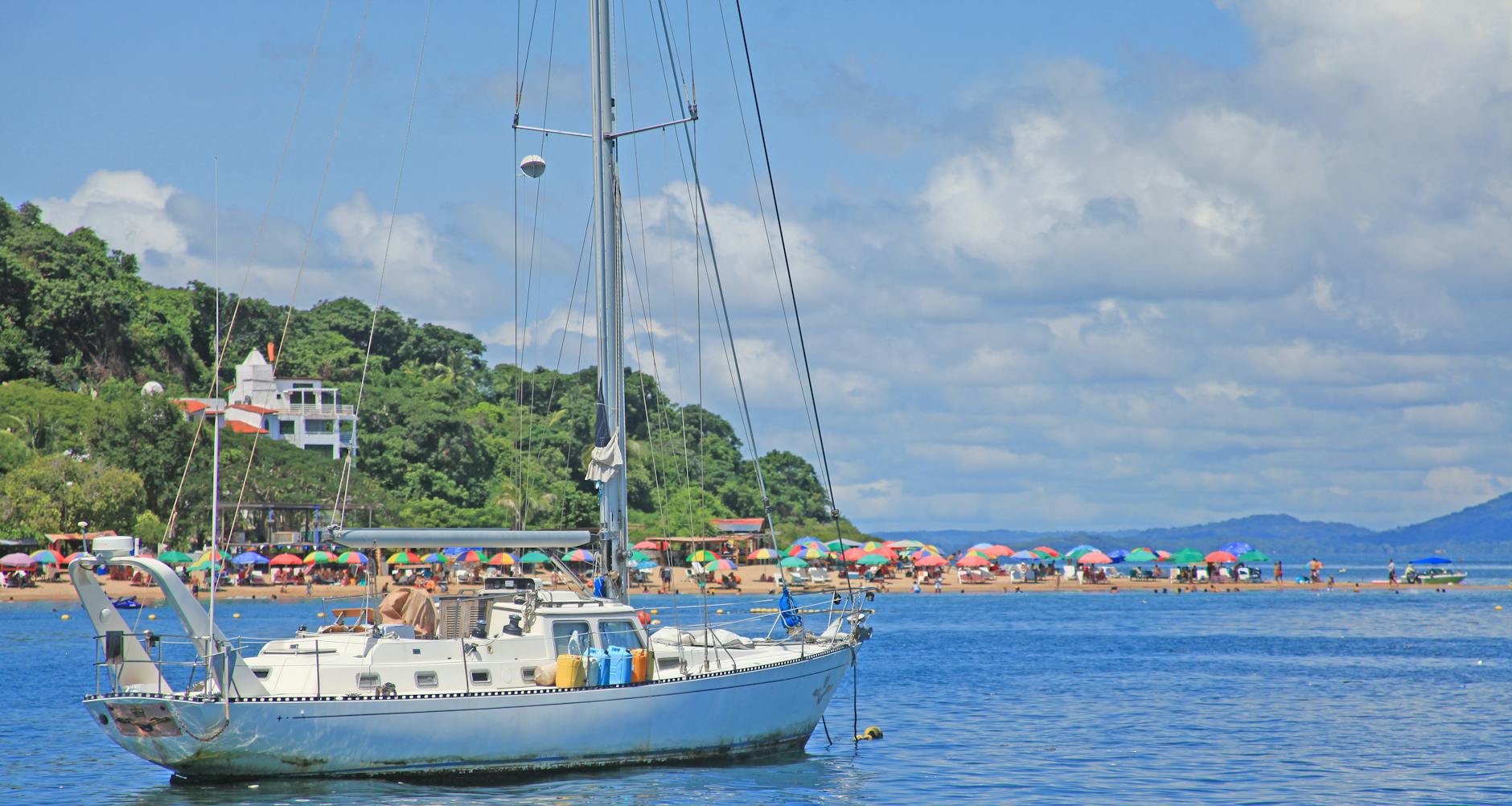 A wooden boat sailing gently on the Nile River with the afternoon sun reflecting on the water.