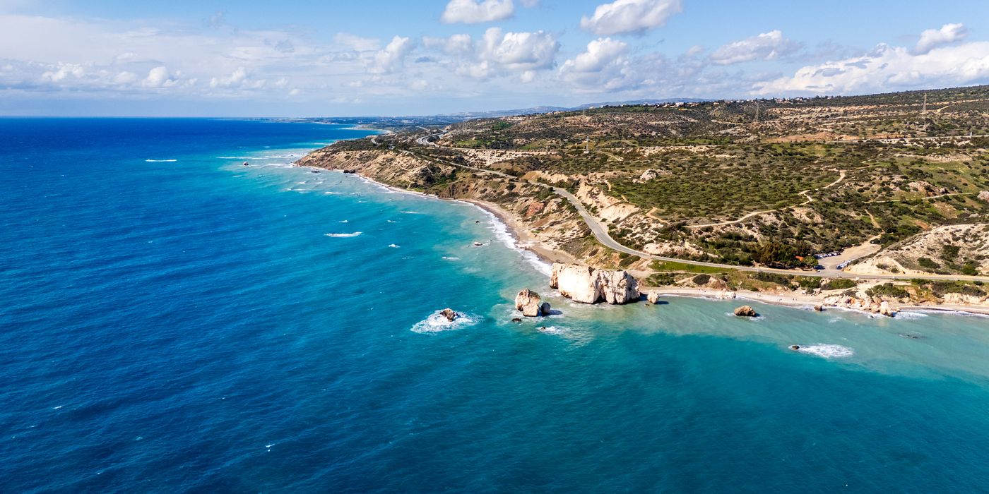 Aerial view of Aphrodite's Rock on the Paphos coastline in Cyprus with turquoise water