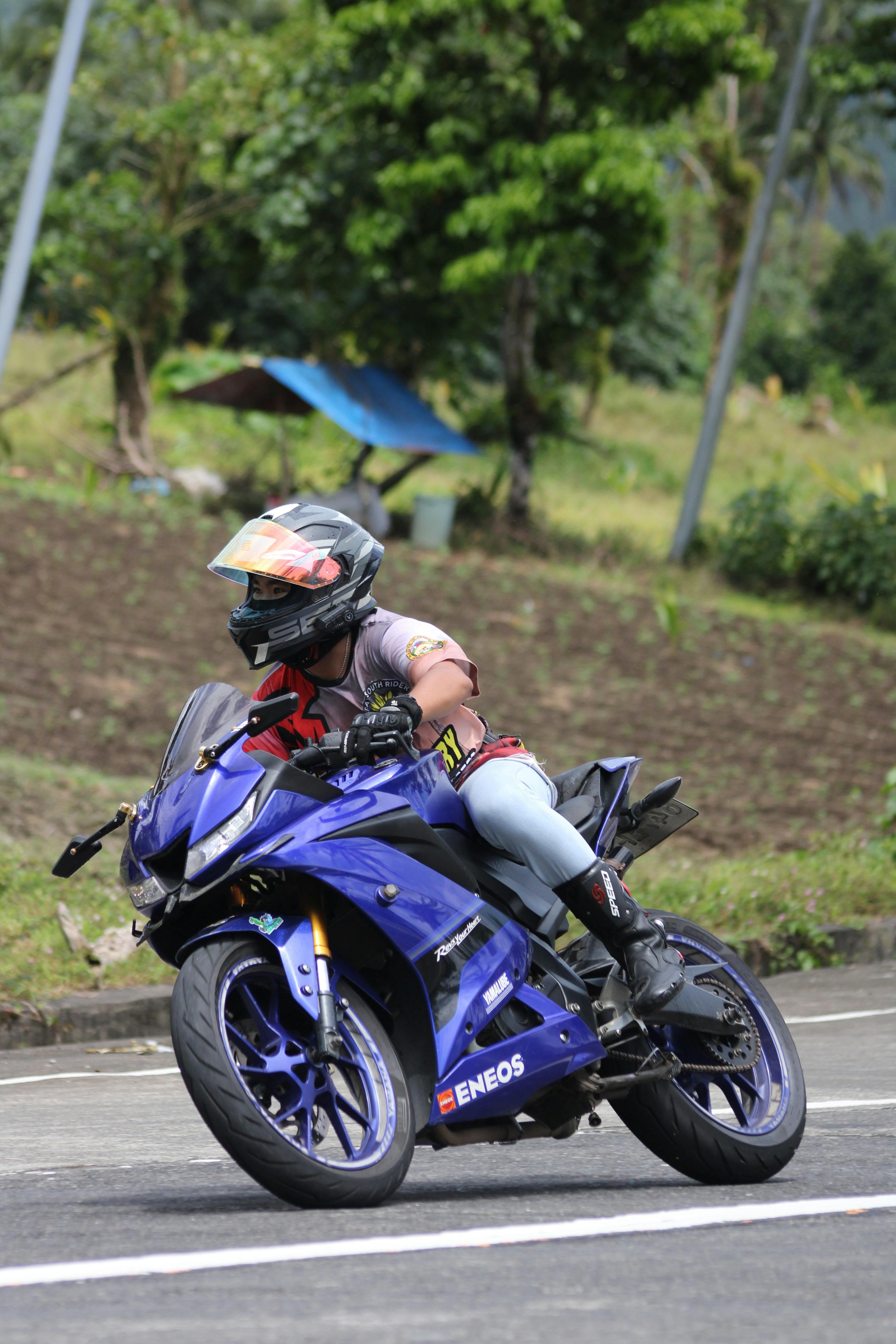 Dynamic shot of a motorcycle racer leaning into a curve on an outdoor track.