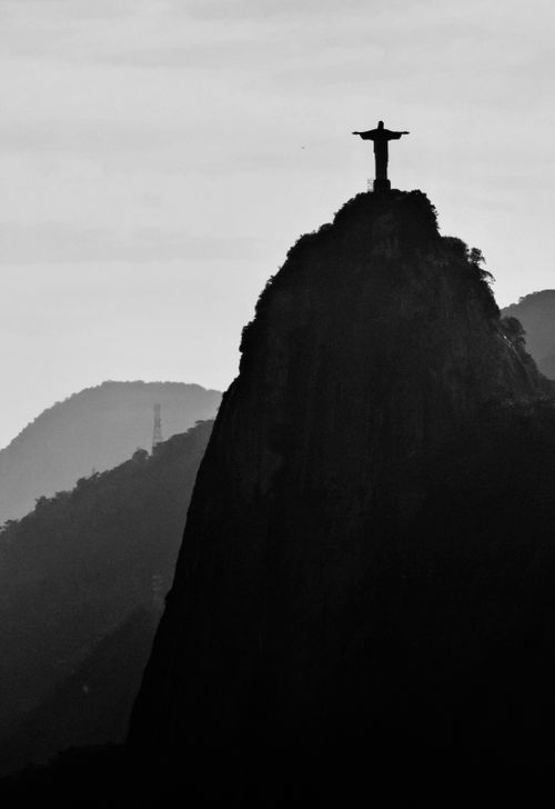 Free Silhouette of Christ the Redeemer statue in Rio de Janeiro against a mountain backdrop. Stock Photo