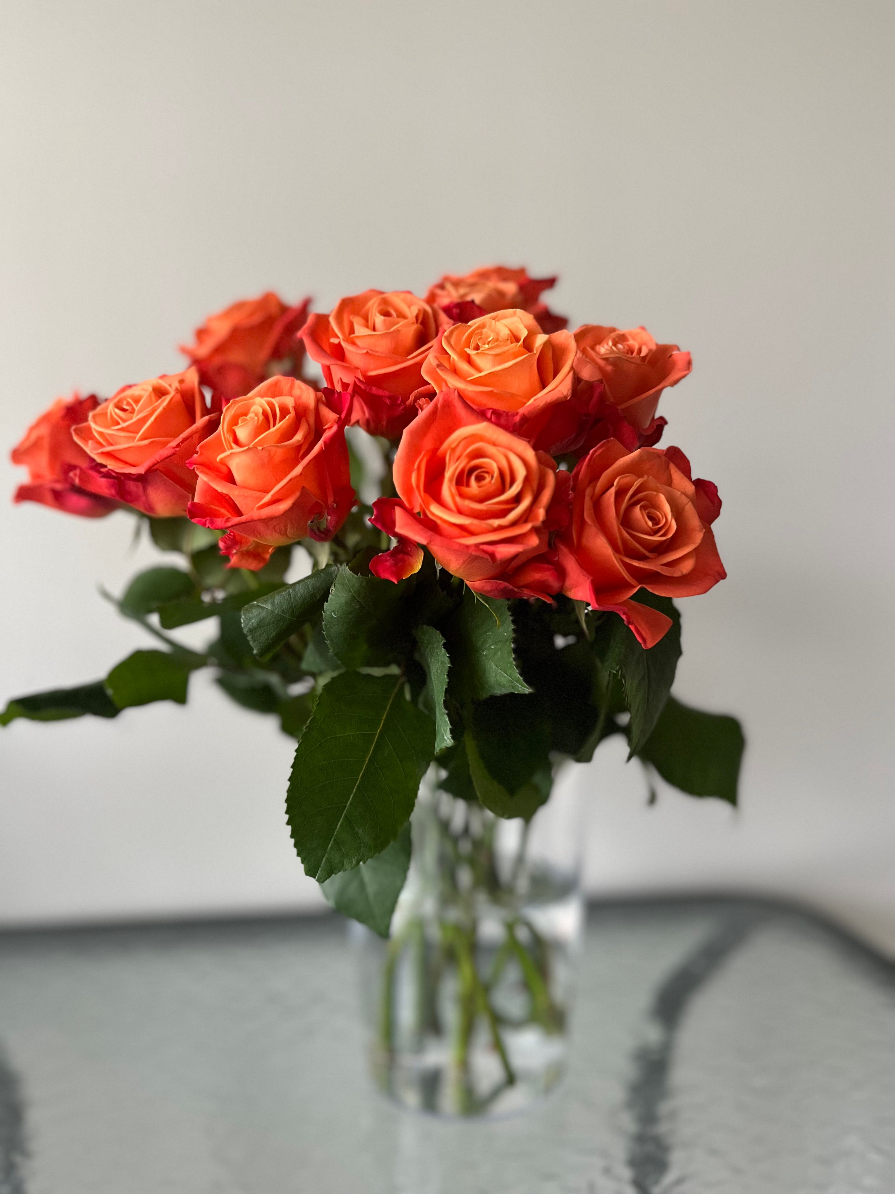 Vibrant Orange Roses in a Glass Vase · Free Stock Photo