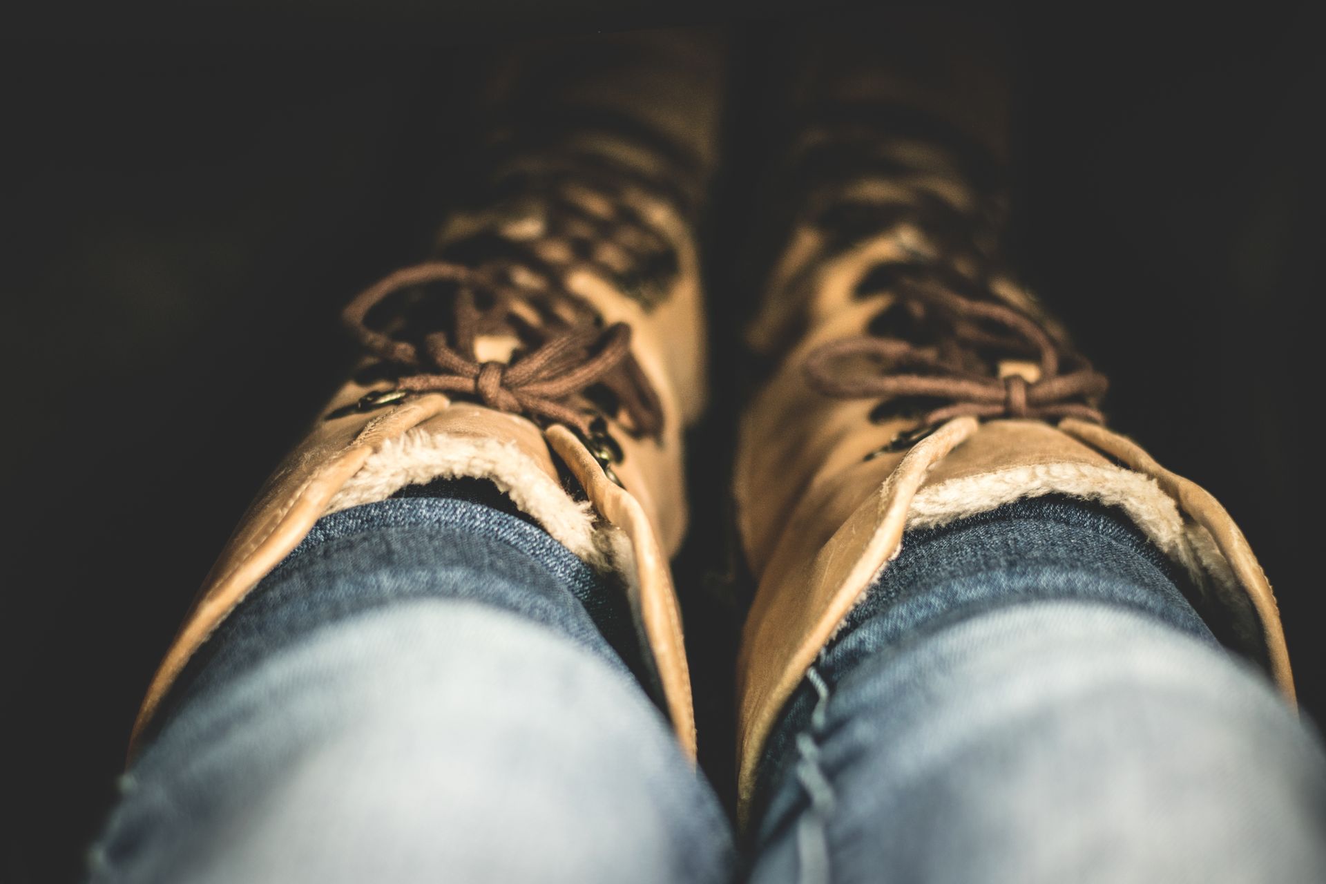 Warm leather boots and denim jeans create a cozy winter fashion look.