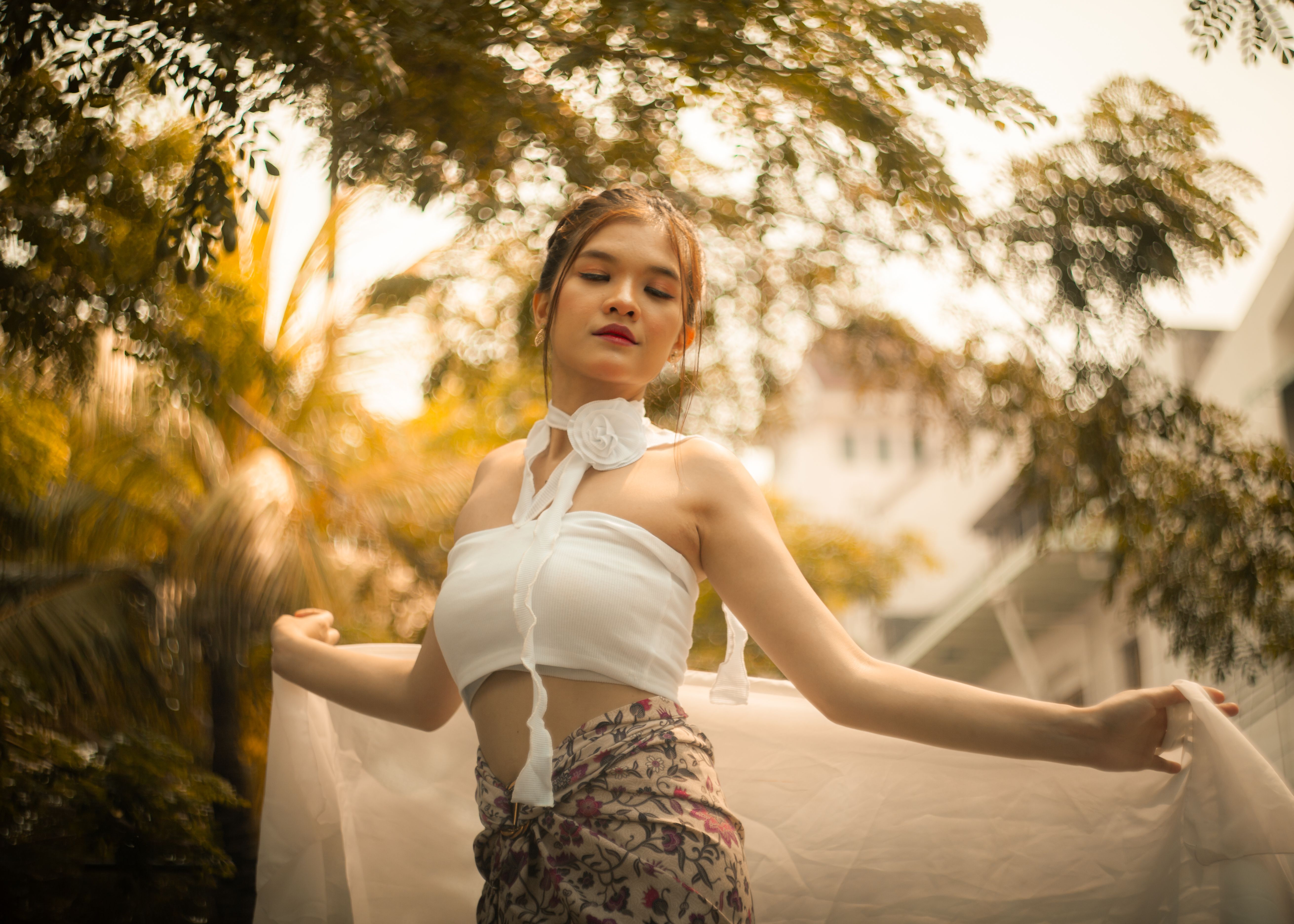 Elegant Woman in Outdoor Setting with Natural Light · Free Stock Photo