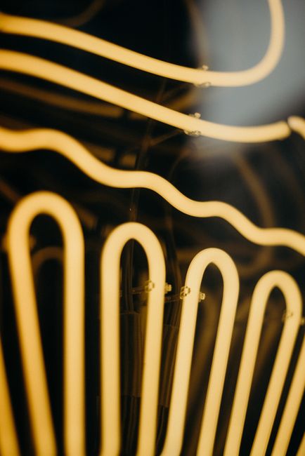 Artistic close-up of glowing neon lights with abstract patterns, perfect for modern decor.