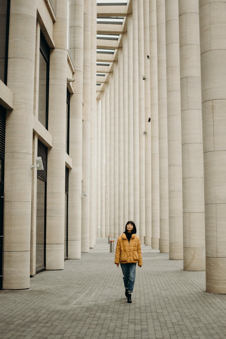 Woman Wearing Yellow Jacket And Blue Denim Jeans