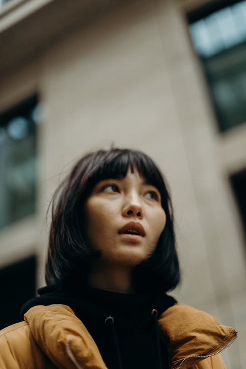 Woman Wearing Black Top and Yellow Jacket