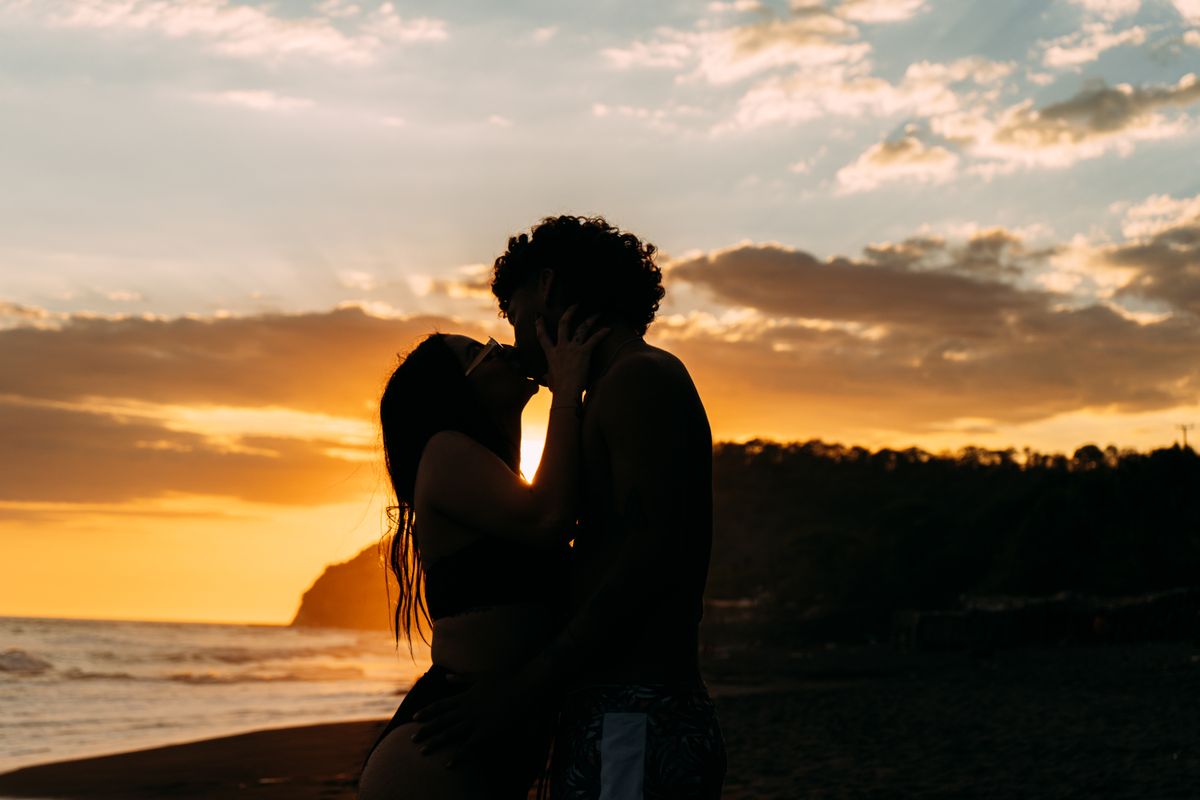 Silhouette of a Couple at the Beach during Sunset · Free Stock Photo